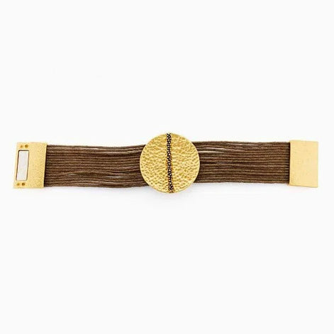 Gold hammered disc bracelet with multiple brown strands and a decorative clasp on white background
