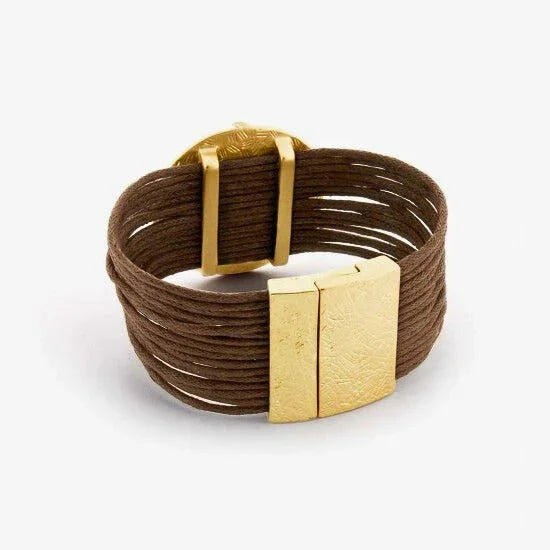 Brown multi-strand bracelet with wide gold clasp, modern statement jewellery on white background