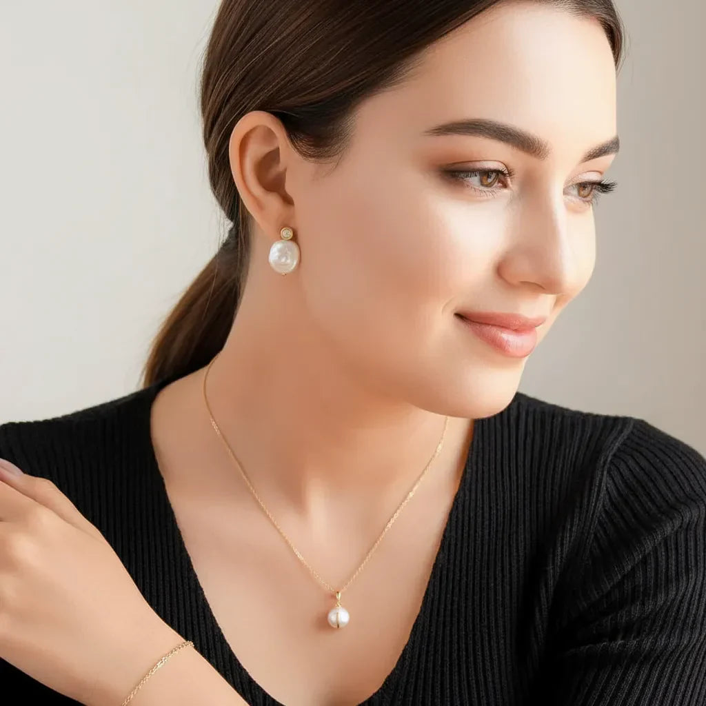 Online Sustainable Gold Necklace New Zealand - Woman wearing gold pearl necklace and pearl stud earrings, elegant jewelry closeup