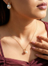 Buy Sustainable Gold Necklace Australia & New Zealand - woman wearing abstract pearl gold necklace with sculptural gold-tone design and luminous pearl accent