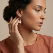 Caracola Gold Hook Earrings with clear cubic zircons and cat eye glass stone in lustrous gold finish