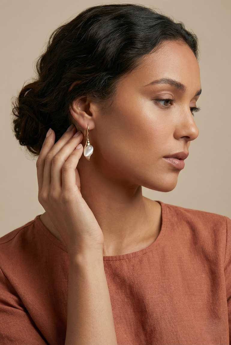 Caracola Gold Hook Earrings with clear cubic zircons and cat eye glass stone in lustrous gold finish