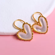 Gold hook earrings with white mother of pearl centerpiece and iridescent shimmer
