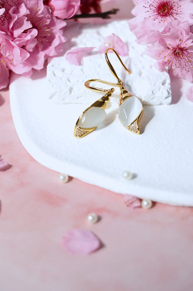 Caracola Gold Hook Earrings with gold finish, cubic zircons, and cat eye glass stone, 38mm length, 11.5mm width