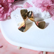 Bow gold earrings with polished bow design in gold plated brass and copper, 31mm length stud earrings