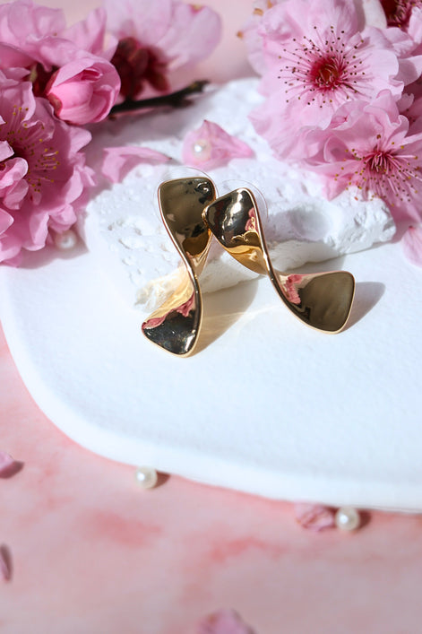 Bow gold earrings with polished bow design in gold plated brass and copper, 31mm length stud earrings