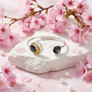 Kirana tri-tone open-style bracelet with dark grey, white, and gold circular accents