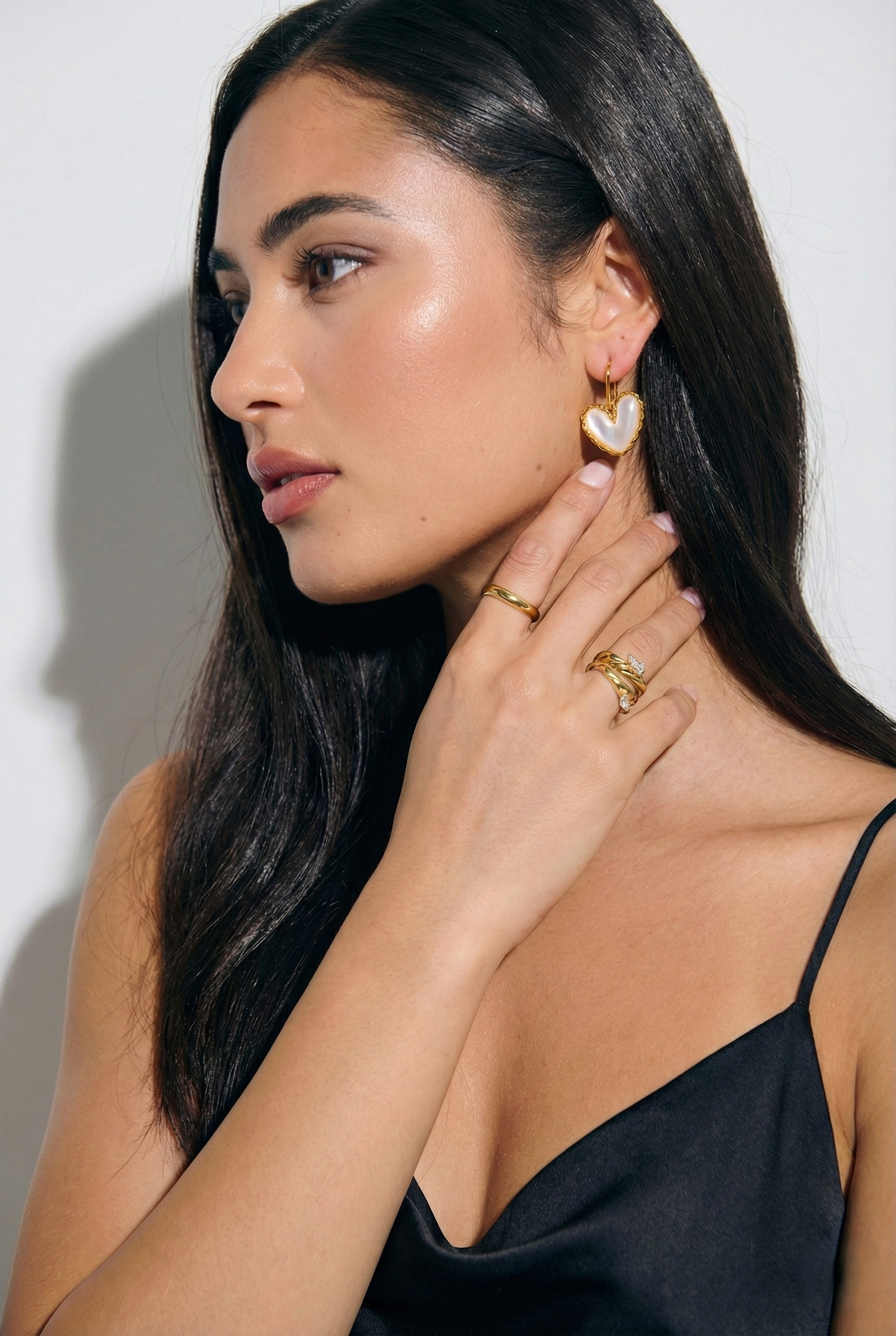 Gold hook earrings with white mother of pearl centerpiece and iridescent shimmer