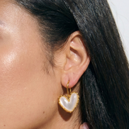 Lovia gold hook earrings with white mother of pearl centerpiece