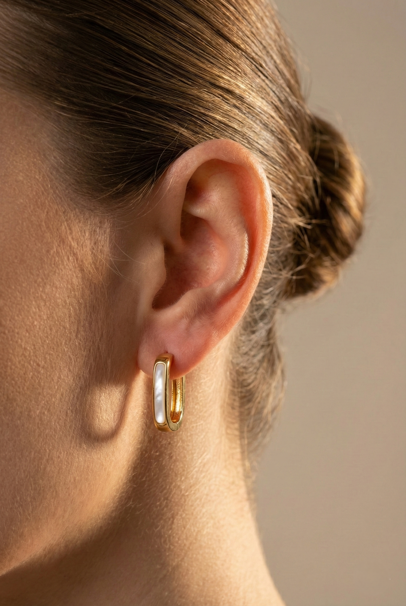 Ollie Mother Of Pearl gold earrings with iridescent mother of pearl and gold plated brass design