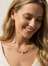Elegant Pearl Gold Necklace Australia NZ - woman wearing One Line Pearl Gold Necklace with adjustable gold-tone chain and pearl detail