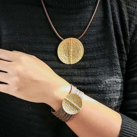 Golden Coin Cord Bracelet Australia & NZ - Woman wearing matching gold hammered disc pendant necklace and bracelet on brown cords