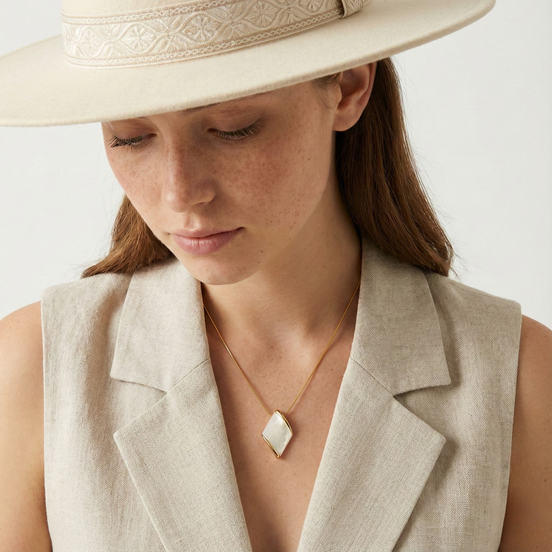 Woman wearing Squarice mother of pearl gold necklace with 38mm pendant and adjustable chain
