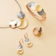 Verona Bracelet with four-tone gold, white, rose gold, and dark grey design on elastic band